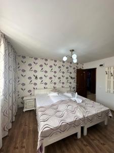 Postel nebo postele na pokoji v ubytování Pensiunea Casa Simoni