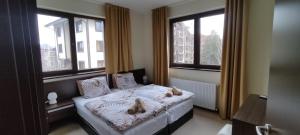 Postel nebo postele na pokoji v ubytování Terra SP apartments-Razlog + 18 fotografií