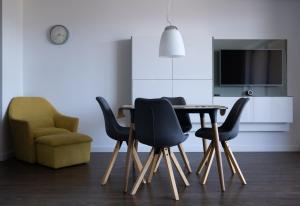 a dining room with a table and a chair at Panoráma Bojnice in Bojnice
