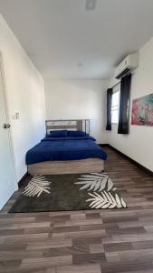 a bedroom with a bed and a rug on the floor at Aileen House in Chiang Mai