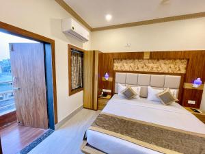 a bedroom with a large bed and a window at Hotel A One Lagoon ! Puri Swimming-pool, near-sea-beach-and-temple fully-air-conditioned-hotel with-lift-and-parking-facility breakfast-included in Puri