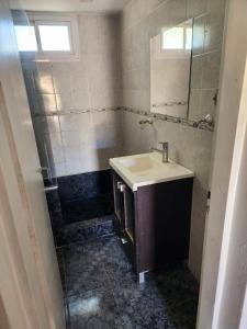 a bathroom with a sink and a shower at Casagrande Centenario in Centenario
