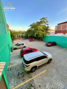 a group of cars parked in a parking lot at Hotel Aconchego Cearense in Fortaleza