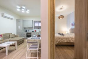 a living room and kitchen with a bed and a table at Panathenaic Stadium By Greece Apartments in Athens