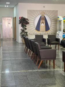 a row of chairs in a waiting room at Hotel Maria da Fé in Aparecida