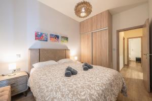 a bedroom with a large bed with two pillows on it at Panathenaic Stadium By Greece Apartments in Athens