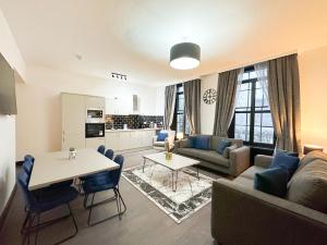 a living room with a couch and a table at Mulberry Aparthotel in Newcastle upon Tyne