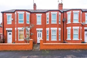a large red brick house with white windows at Spacious 4-Bed House Manchester in Manchester