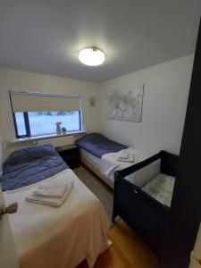 a bedroom with two beds and a mirror at Excellent location in Keflavík at Faxabraut 49. in Keflavík