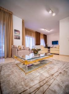 a living room with a couch and a table at Yianni's Home-Comfort Apartment in Volos in Volos