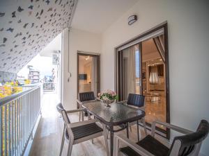 a dining room with a table and chairs and a balcony at Yianni's Home-Comfort Apartment in Volos in Volos