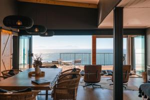 a dining room with a view of the ocean at Klein-Hangklip in Rooiels