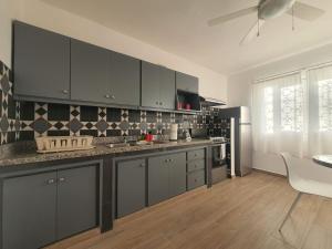 a kitchen with gray cabinets and a counter top at Apartamento bayahibe in Bayahibe