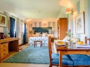 a bedroom with a bed and a table and a dining room at 1 Bed in St Neots 78984 in Wyboston