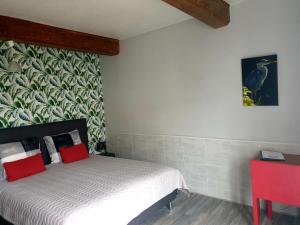 1 dormitorio con 1 cama y una pintura en la pared en Le Heron Pourpre B&B gastronomique, en Cronat