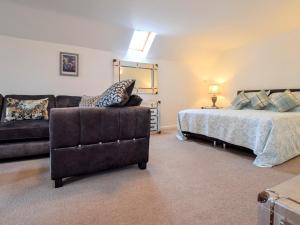 a living room with a bed and a couch at 1 bed property in Filey 79278 in Wold Newton