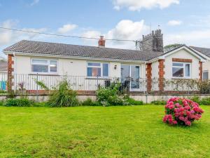 a house with a fence and a yard at 3 Bed in Langtree 79041 in Langtree