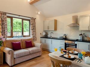 a kitchen and living room with a couch and a table at 1 bed in Builth Wells BN201 in Aberedw