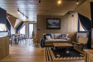 a living room with a couch and a table at Rozmus Apartamenty in Bukowina Tatrzańska