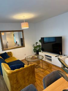 a living room with a couch and a flat screen tv at 3-Bedroom Apartment In The Heart of London in London