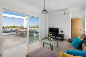 a living room with a couch and a table at Villa Katerina - Soroni in Rhodes Town
