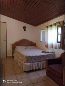 a bedroom with a bed and a window and a couch at Sarah Delight in Pýrgos