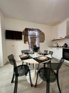 a kitchen with a table and chairs with food on it at Piazza Roma apartment next como lake and station by revenue house in Como