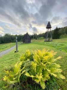 a field with a house and a gazebo at Hållandsgården in Järpen