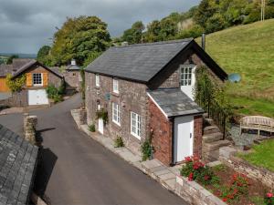 a brick house with a black roof on a street at 1 Bed in Bwlch BN270 in Llansantffread