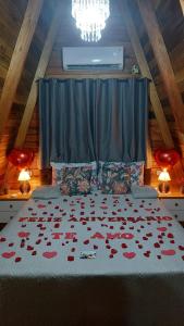 a bedroom with a bed with hearts on it at Vista dos Canyons in Praia Grande