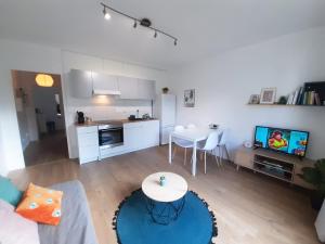 a living room with a couch and a table and a kitchen at GITES des FLANDAINES in Saint-Jean-en-Royans
