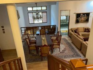 a dining room and living room with a table and chairs at Casa Setra Bandung in Bandung