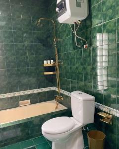 a bathroom with a toilet and a bath tub at Casa Setra Bandung in Bandung