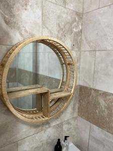 a bathroom mirror with a wooden frame on a wall at 3-Bedroom Apartment In The Heart of London in London