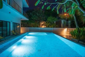 a swimming pool at night in a house at Phi Phi Ton Sai Place in Phi Phi Don