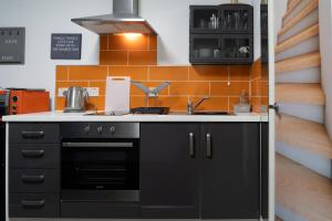 a kitchen with a sink and a stove at ALTIDO Trendy City Centre Studio in Birmingham