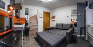 a living room with a bed and a staircase at ALTIDO Trendy City Centre Studio in Birmingham