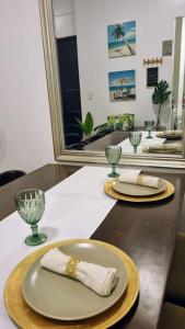a table with two plates and glasses on it at Lushfield Boracay Guest House in Boracay