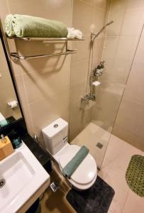 a bathroom with a shower and a toilet and a sink at Lushfield Boracay Guest House in Boracay +18 photos