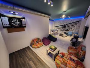 ein Wohnzimmer mit Stühlen und einer Uhr an der Wand in der Unterkunft Apartman 18 in Debrecen