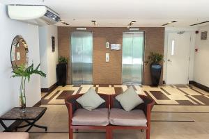 a lobby with a couch and a table at Lushfield Boracay Guest House in Boracay