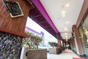 a building with a purple ceiling and a walkway at Lavender Inn Nusa Bestari in Johor Bahru