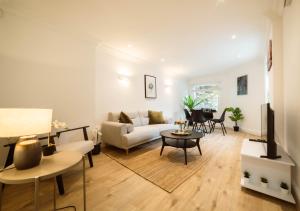 a living room with a couch and a table at 4 Bedrooms Peaceful Home Abbey Rd - St Johns Wood in London