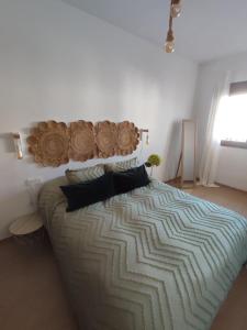a bedroom with a large bed with a large comforter at VISTA ALMIJARA in Frigiliana