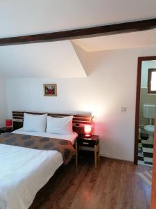 a bedroom with a bed and a table with a lamp at Cabana Gabriel Bucovina in Vatra Dornei +128 photos