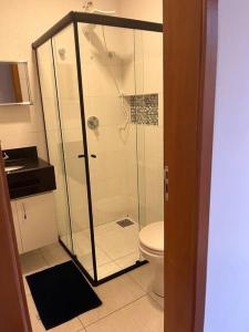 a bathroom with a shower and a toilet at Flat - Suíte Trocadéro - 112 in Lagoa Santa