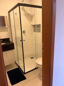a bathroom with a shower and a toilet at Flat - Suíte Trocadéro - 112 in Lagoa Santa +6 photos