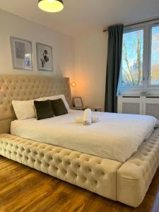 a large bed in a bedroom with a large window at 3-Bedroom Apartment In The Heart of London in London