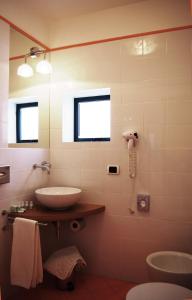 a bathroom with a sink and a mirror at La Piccola Locanda in Modica