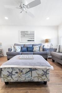 a living room with a couch and a table at Ocean Block Condo 100 Steps From the Beach in Ocean City